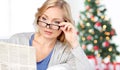 Woman in eyeglasses reading newspaper at christmas Royalty Free Stock Photo