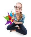 Woman in eyeglasses sitting on floor with windmill Royalty Free Stock Photo