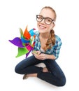 Woman in eyeglasses sitting on floor with windmill Royalty Free Stock Photo