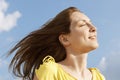 Woman With Eyes Closed Enjoying Sunlight Against Sky