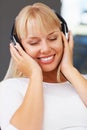 Woman with eyes closed listening to music. Closeup of relaxed young woman listening to headphones.
