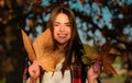 Woman face in autumn outdoor. Girl portrait with yellow leaves. Young girl hold oak and maple leaf outdoor. Fall autumn