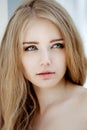 Woman face close up. A pretty young blond trendy. Girl with a be Royalty Free Stock Photo