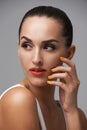 Woman, face and manicure with lipstick for beauty, yellow nail polish and cosmetics on grey background. Cosmetology Royalty Free Stock Photo