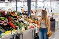 Woman with face mask buying fruit and vegetables at the central city market Royalty Free Stock Photo