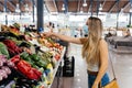 Woman with face mask buying fruit and vegetables at the central city market Royalty Free Stock Photo