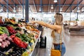 Woman with face mask buying fruit and vegetables at the central city market Royalty Free Stock Photo