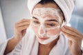 Woman, face mask and cotton pad, facial treatment and detox dermatology after shower in home bathroom. Young female