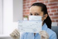 Woman In Face Mask Holding Paycheck Royalty Free Stock Photo