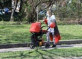Woman with face mask for protection from coronavirus push a stroller in the street in Sofia, Bulgaria on 04/16/2020
