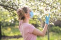 Woman with face mask on quarantine. Stay at home. Family concept. young woman blowing dandelion. glass of champagne on the beach.G