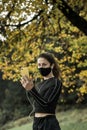 Woman with face mask taking video call. Giving lectures while working out during covid-19