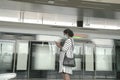 Woman with face mask on waiting for train at the platform of a subway station Royalty Free Stock Photo