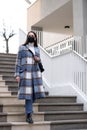 Woman with face mask walking down stairs Royalty Free Stock Photo