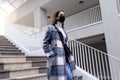 Woman with face mask walking down stairs Royalty Free Stock Photo