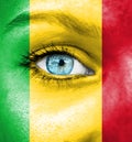 Woman face painted with flag of Mali Royalty Free Stock Photo