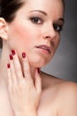 Woman face with red fingernail Royalty Free Stock Photo