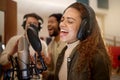 Woman, face or singing on studio microphone with backup singers in album, song or radio recording. Artist, musician or Royalty Free Stock Photo