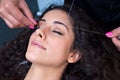 Woman on facial hair removal threading procedure