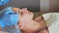 Woman with facial mask, spa treatment. Antiage beauty procedure.