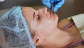 Woman with facial mask, spa treatment. Antiage beauty procedure.
