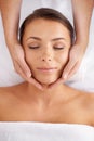 Woman, facial and massage at spa from above for beauty, skincare treatment and healing at cosmetics salon. Face of calm Royalty Free Stock Photo