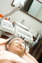 Woman in facial treatment using herbal steamer