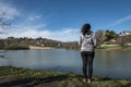 The woman facing the lake