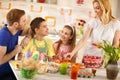 Woman with family preparing Easter basket with eggs Royalty Free Stock Photo