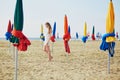 Woman with famous colorful parasols on Deauville Beach in France Royalty Free Stock Photo