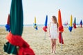 Woman with famous colorful parasols on Deauville Beach in France Royalty Free Stock Photo