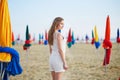 Woman with famous colorful parasols on Deauville Beach in France