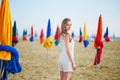 Woman with famous colorful parasols on Deauville Beach in France Royalty Free Stock Photo