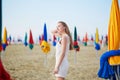 Woman with famous colorful parasols on Deauville Beach in France Royalty Free Stock Photo