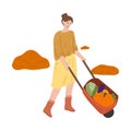 Woman farmer carrying picked vegetables in wheelbarrow during harvesting