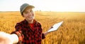 Woman farmer with digital tablet makes selfie