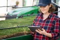 Woman farmer with digital tablet next to a pipe for irrigation. Royalty Free Stock Photo