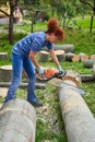 Woman farmer using the chainsaw