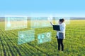 A woman farmer selects on a virtual screen the parameters that control the growth of the crop and analyzes the data using artifici