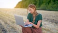 Woman farmer smart farming standing farmland smiling using laptop Female agronomist specialist research monitoring analysis data Royalty Free Stock Photo