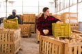 Woman farmer sorting fresh pumpkins