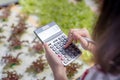 Woman farmer use Calculator checking stock and price hydroponics vegetables Royalty Free Stock Photo