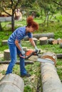 Woman farmer using the chainsaw