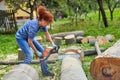 Woman farmer using the chainsaw