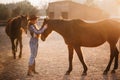 Woman farmer works with horses.