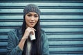 Woman, fashion and coffee with portrait, urban and city street or background for style. Asian student, beanie and jacket