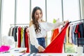 Woman fashion designer using tape for measuring mannequin creating pret-a-porter collection in showroom, concentrated owner of Royalty Free Stock Photo