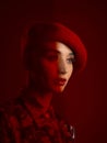Woman, fashion and face with red aesthetic, beauty and makeup with vintage hat isolated on studio background. Retro