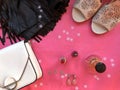 Woman fashion party flat lay. Party style. Black leather skirt with fringe, white bag, perfume, red lipstick, red nail valish,