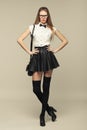 Woman is in fashion style in black mini skirt. Fashion girl